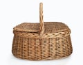 Front view of natural wicker basket with handle and lids on both sides isolated on white background. Handmade raffia picnic basket