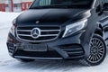 Front view of new a expensive Mercedes Benz V-class minivan bumper and hood of a car, a long black limousine, model outdoors, Royalty Free Stock Photo