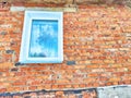 Front view of new plastic windows in an old red brick wall. Abstract background, texture, pattern, copy space and place Royalty Free Stock Photo