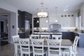 Front view of a newly designed kitchen and a dinning table inside a model home