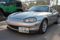 light sports car, the Mazda Miata MX-5 NB, parked in the street.