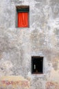 Front view of a old and aged facade with two small windows Royalty Free Stock Photo