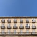 Front view of an old building facade full of balconies with blue sky and copy space Royalty Free Stock Photo