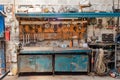 Front view an old collection of various repair tools hangs on the wall above the table. Workshop with tools Royalty Free Stock Photo