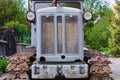 Front view of old crawler tractor. Detailed view of tractor. Soviet gray crawler. Nature landscape background. Front-bottom view Royalty Free Stock Photo