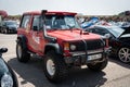 Front view of an old red all-terrain Mitsubishi Montero parked on the street