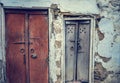 A front view of old vintage wood carved closed doors of an old house with cracked wall in streets of Lohara village in Ludhiana, P Royalty Free Stock Photo