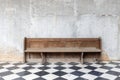 Front view of old single wooden bench on checkered pattern marble tiles floor with brick and cement wall background in church Royalty Free Stock Photo