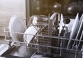 Open dishwasher with clean utensil inside, cutlery, glasses, dishes at kitchen Royalty Free Stock Photo