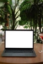 Front view of open laptop computer with blank monitor white screen display on table in cafe. Workspace office modern for Royalty Free Stock Photo