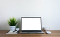 Front view of open laptop computer notebook with blank monitor white screen display on work table desk. Royalty Free Stock Photo