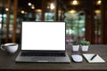 Front view of open laptop computer notebook with blank monitor white screen display on work table desk. Royalty Free Stock Photo