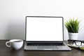 Front view of open laptop computer notebook with blank monitor white screen display on work table desk. Royalty Free Stock Photo