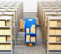 Front view of orange robot carriers carrying goods in modern warehouse