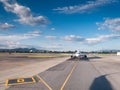 front view of a passenger jet airplane ready to take off on an airport runway