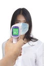 Front view photo of woman who was being measured body temperature with electronic handheld thermometer