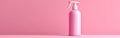 A front view of a pink spray bottle with a label, placed on a pink background Royalty Free Stock Photo