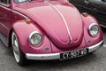 Front view of pink Volkswagen beetle parked in the street Royalty Free Stock Photo