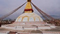 Front view of popular Buddhist monument Boudhanath Stupa (Boudha) decorated with colorful prayer flags and garlands. Royalty Free Stock Photo