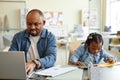 Single father working from home with child Royalty Free Stock Photo