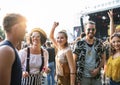 Front view portrait of group of young friends dancing at summer festival. Royalty Free Stock Photo