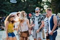 Front view portrait of group of young friends dancing at summer festival. Royalty Free Stock Photo