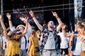 Front view portrait of group of young friends dancing at summer festival. Royalty Free Stock Photo