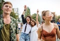 Front view portrait of group of young friends dancing at summer festival. Royalty Free Stock Photo