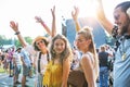 Front view portrait of group of young friends dancing at summer festival. Royalty Free Stock Photo