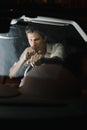 Front view. Portrait of a handsome man driving his car at night. The traffic lights behind him Royalty Free Stock Photo