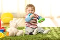 Baby biting toys on a carpet