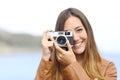 Happy photographer taking photo with a vintage camera