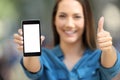 Positive woman showing a blank smart phone screen