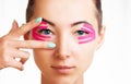 Beautiful woman with kinesiology tapes on eyelid.