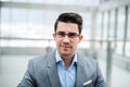 A front view of portrait of young businessman indoors in an office. Royalty Free Stock Photo