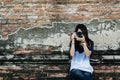 Front view portrait young woman photographer holding camera and Royalty Free Stock Photo