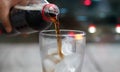 Front view, Pouring cola soda beverage with ice and bubble