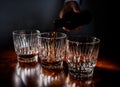 Front view of Pouring strong alcohol drink into the clean glasses Royalty Free Stock Photo