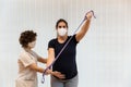 A pregnant woman exercising with an elastic band with help of physiotherapist Royalty Free Stock Photo