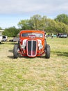 Front view of a rebuilt classic red hot rod vehicle