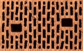 Front view of red brick with black holes Royalty Free Stock Photo