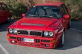 Front view of a red Lancia Delta HF on the street