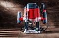 Front view red speed variable power small plunge router milling machine portable electric hand mini wood router on vintage wooden Royalty Free Stock Photo