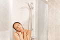 Relaxed woman taking a shower in a hotel Royalty Free Stock Photo