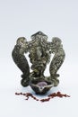 An ornate statue of ganesh / ganesha statue holding a rose quartz, surrounded by red chakra stones on an isolated white background Royalty Free Stock Photo
