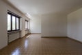 Front view room with dirty white walls and brown tiles. Interior of empty old villa to be refurbished Royalty Free Stock Photo