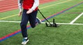 Front view of runner pulling a weighted sled on a field next to a track Royalty Free Stock Photo