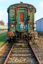 Front view of rusty and corroded green metal freight car on disused train tracks Royalty Free Stock Photo