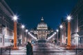 Front View of Saint Peter`s Basilica in Vatican, night view of the church and road with a couple standing in front