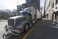 Semi truck and trailer parked on urban downtown street